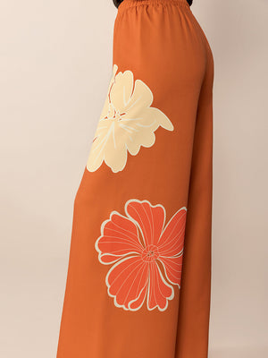 Seventies floral palazzo trousers in tangerine with large cream and orange flower prints.