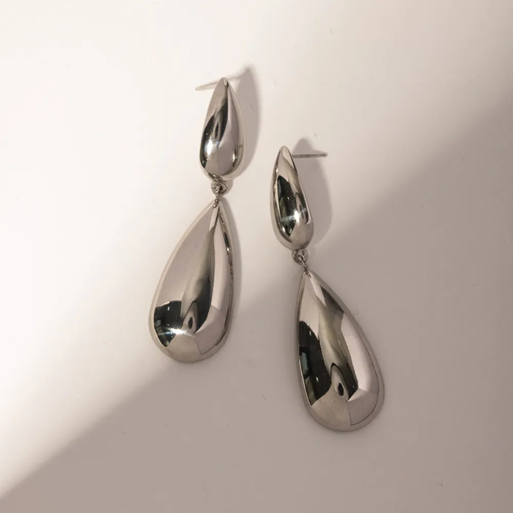 Silver teardrop dangle earrings with a high-shine polished finish.