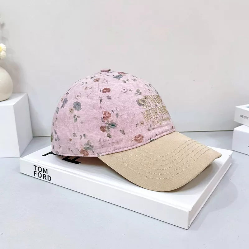 Pink floral cotton baseball cap with beige brim and embroidered text