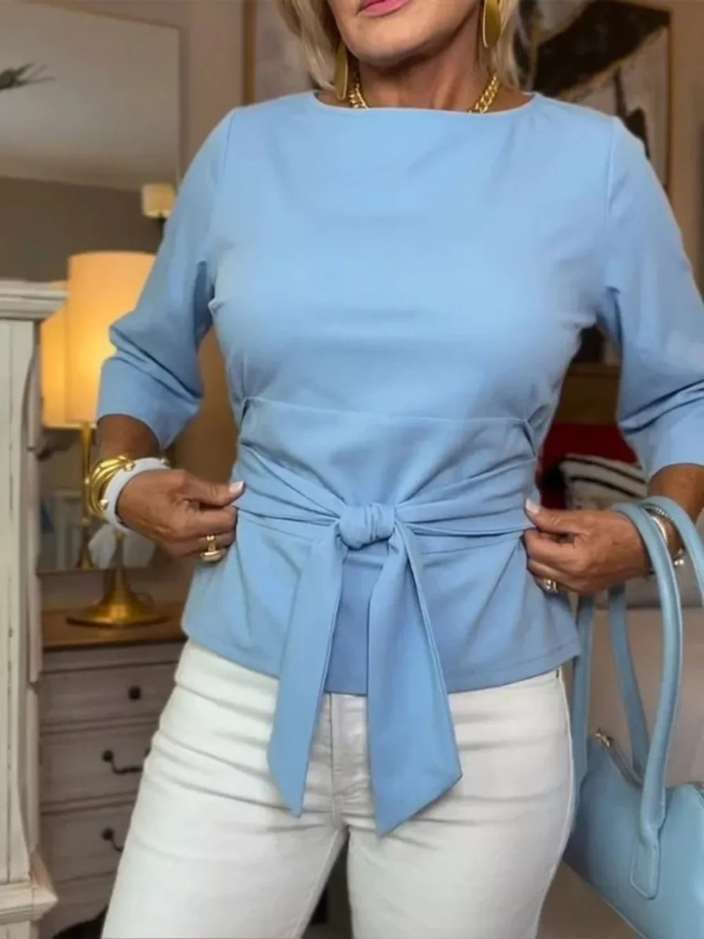 Light blue 3/4 sleeve t-shirt with a tie-waist detail, crew neck.