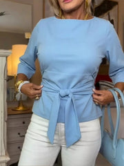 Light blue 3/4 sleeve t-shirt with a tie-waist detail, crew neck.