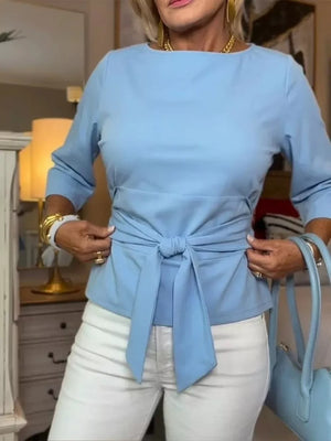 Light blue 3/4 sleeve t-shirt with a tie-waist detail, crew neck.