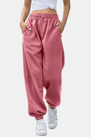 Dusty pink sweatpants with gathered cuffs and drawstring waist.