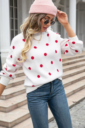 White polka dot knit sweater with balloon sleeves and crew neck.