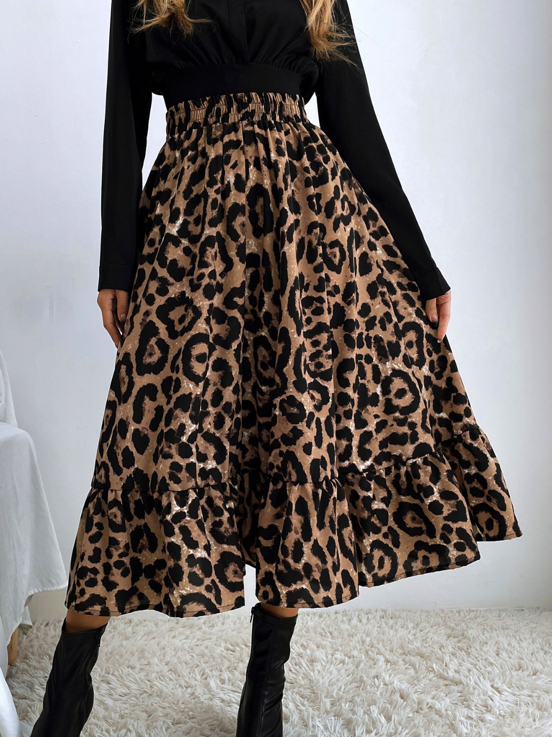 Leopard print tiered midi skirt with elastic waistband and ruffled hem.