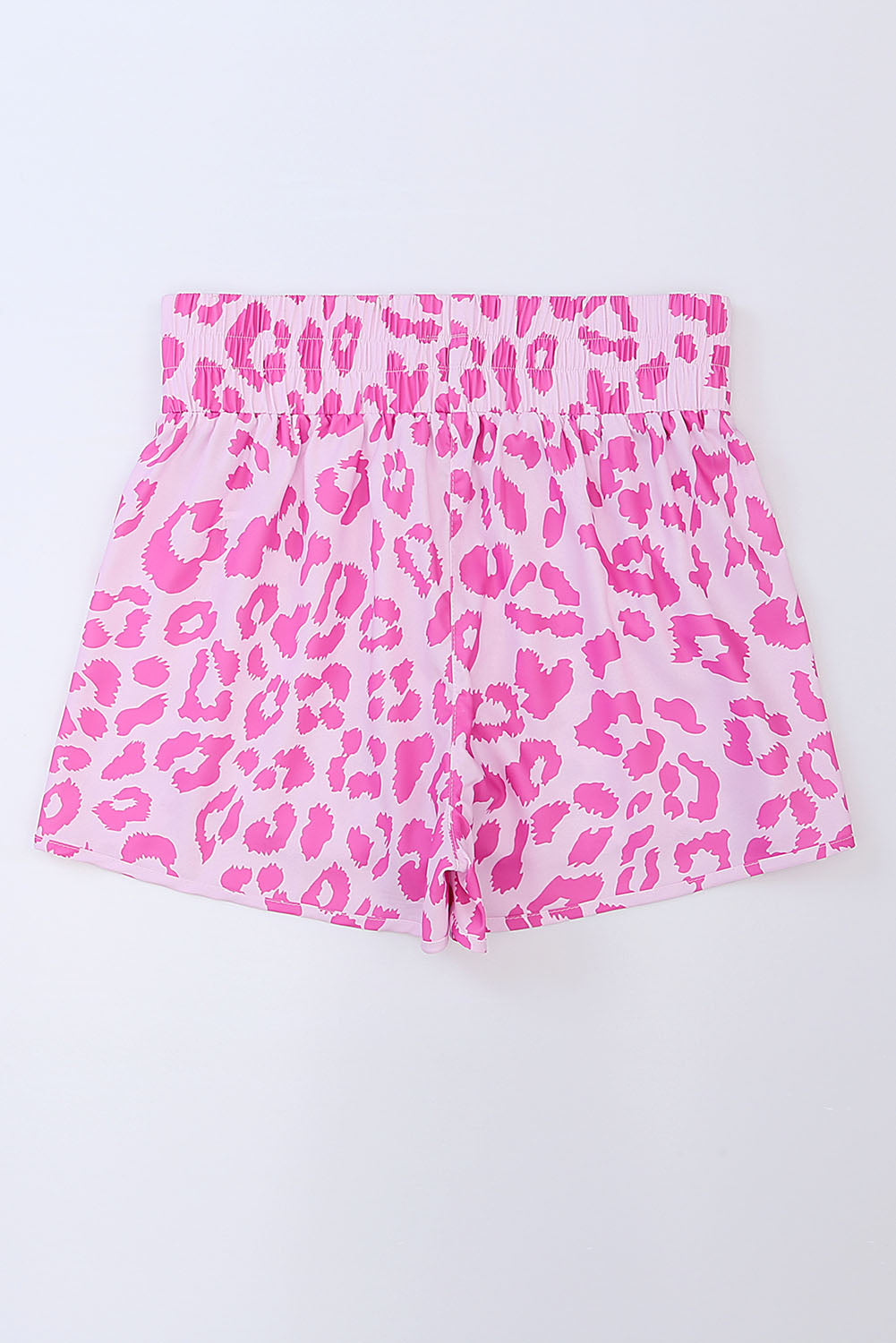 Pink leopard print shorts with elastic waistband and scalloped hem.