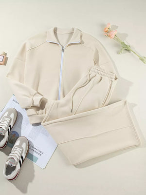 Beige cotton zip-up jacket and drawstring pants set with elastic waistband and cuffs.