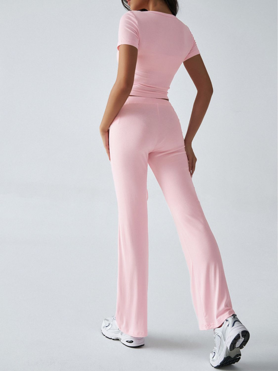 Blush pink crop top and flared lounge pants set with short sleeves.