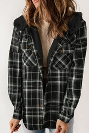 Sherpa-lined plaid overshirt jacket in black and white with button front and chest pockets.