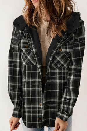 Sherpa-lined plaid overshirt jacket in black and white with button front and chest pockets.