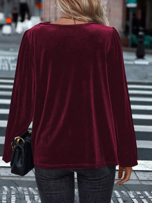 Burgundy velvet long sleeve blouse with cowl neck and puff sleeves.