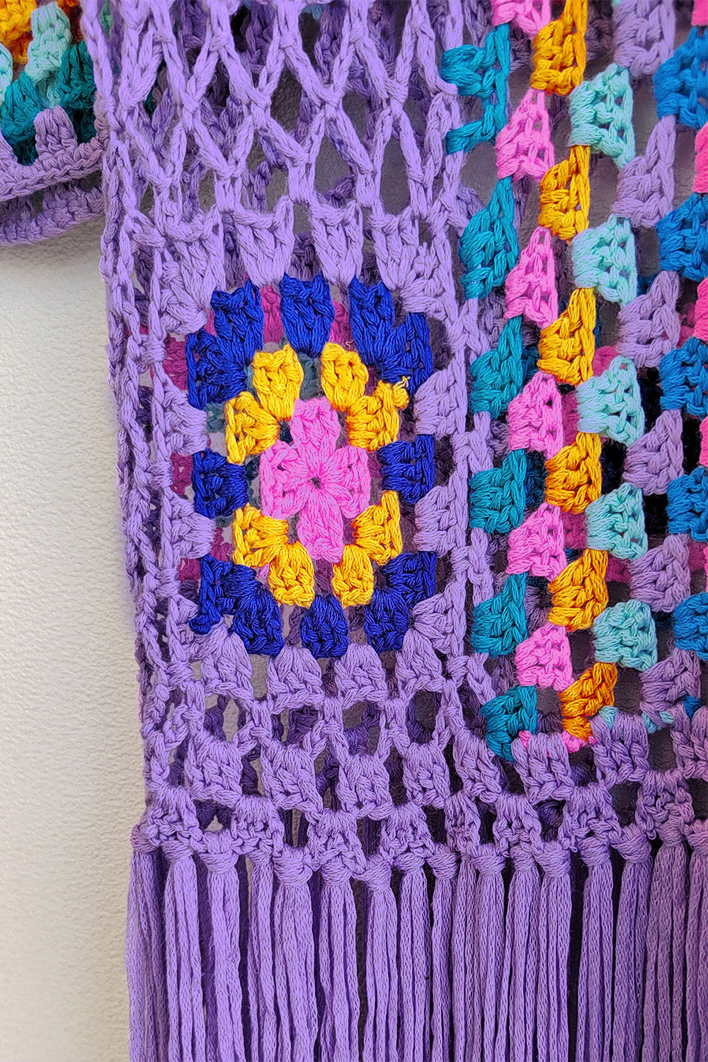 Lilac crochet duster with granny square pattern and fringe detail.