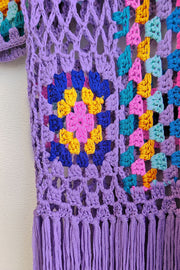 Lilac crochet duster with granny square pattern and fringe detail.