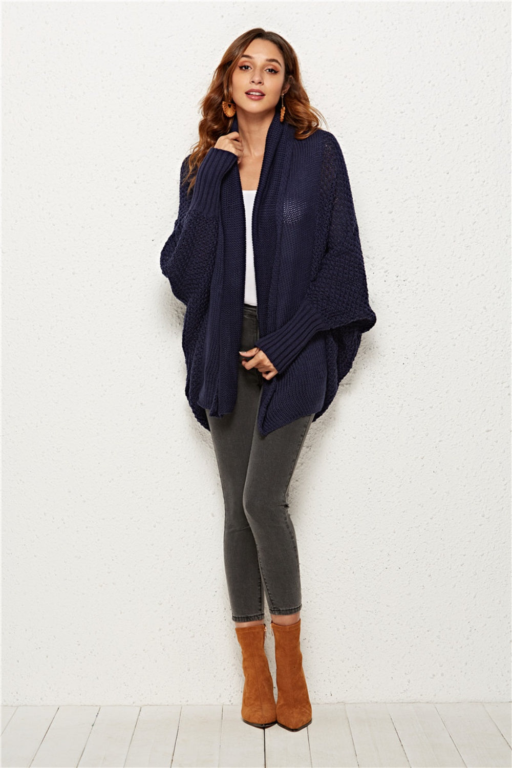 Textured cocoon knit cardigan in dark blue with batwing sleeves and shawl collar.