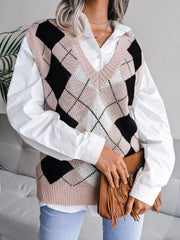 Argyle knit v-neck sweater vest in dusty pink with black and white diamond pattern, layered over a white shirt.