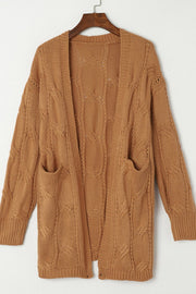 Camel cable knit open-front cardigan with pockets and intricate stitch detail.