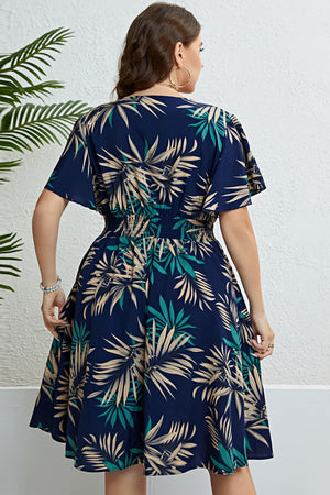 Dark navy midi dress with empire waist, flutter sleeves, and a tropical palm print.