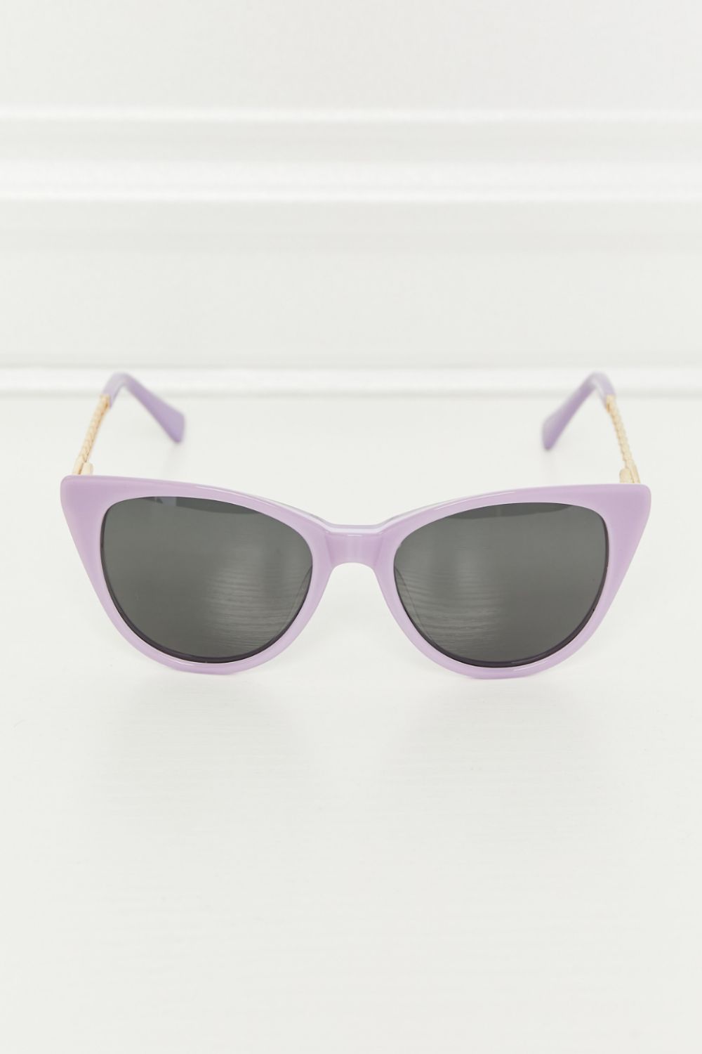 Lavender cat-eye acetate sunglasses with chain detail and dark lenses