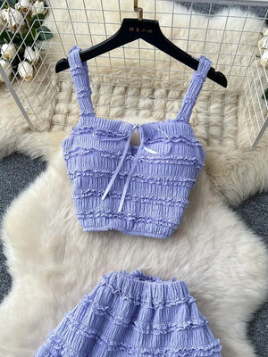Purple ruched crop top and maxi skirt set with tie detail.