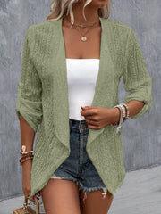 Sage open-weave cardigan with draped front and rolled sleeves, styled with denim shorts.