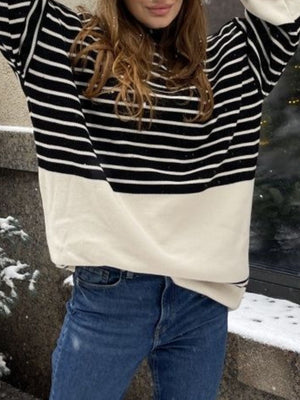 Colorblock stripe knit sweater with bell sleeves in black and cream.