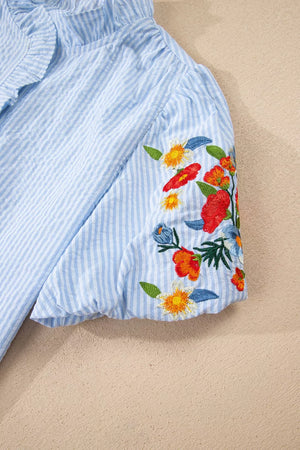 Blue striped cotton shirt with embroidered floral detail on puff sleeve and frill neckline.