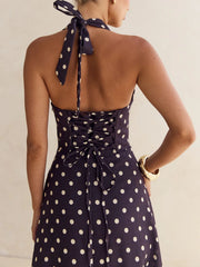 Navy polka dot halter maxi dress with lace-up back detail