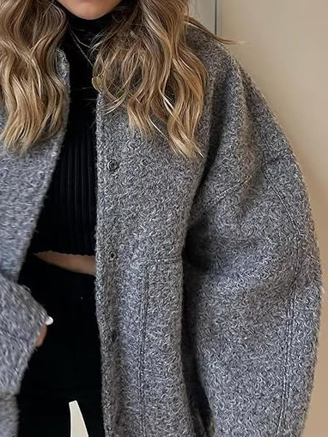 Dark Gray bouclé cocoon jacket with snap closure and textured material.