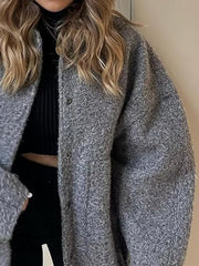 Dark Gray bouclé cocoon jacket with snap closure and textured material.