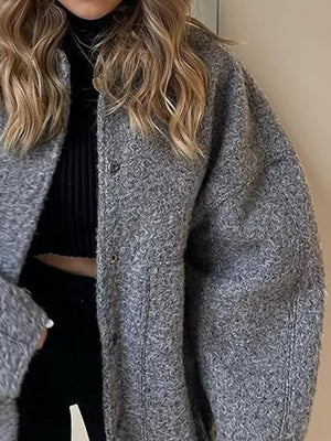 Dark Gray bouclé cocoon jacket with snap closure and textured material.
