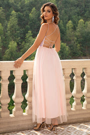 Blush pink tulle maxi dress with sequin bodice and backless lace-up detail.