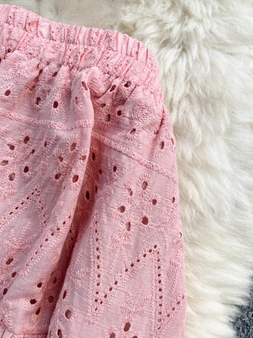 Pink eyelet maxi skirt with elastic waistband and embroidered detail