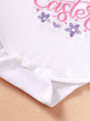 White cotton baby bodysuit with pink and purple floral embroidery and snap closures.