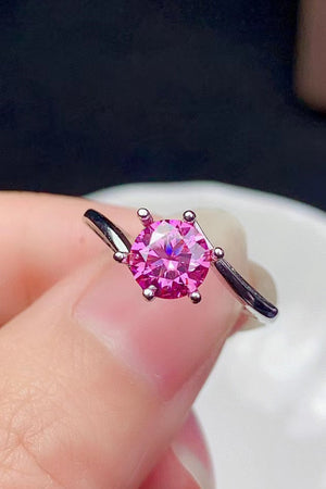 Radiant pink moissanite solitaire ring with a six-prong setting.