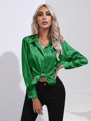 Green satin leopard print tie-front blouse with button-down front and long sleeves.