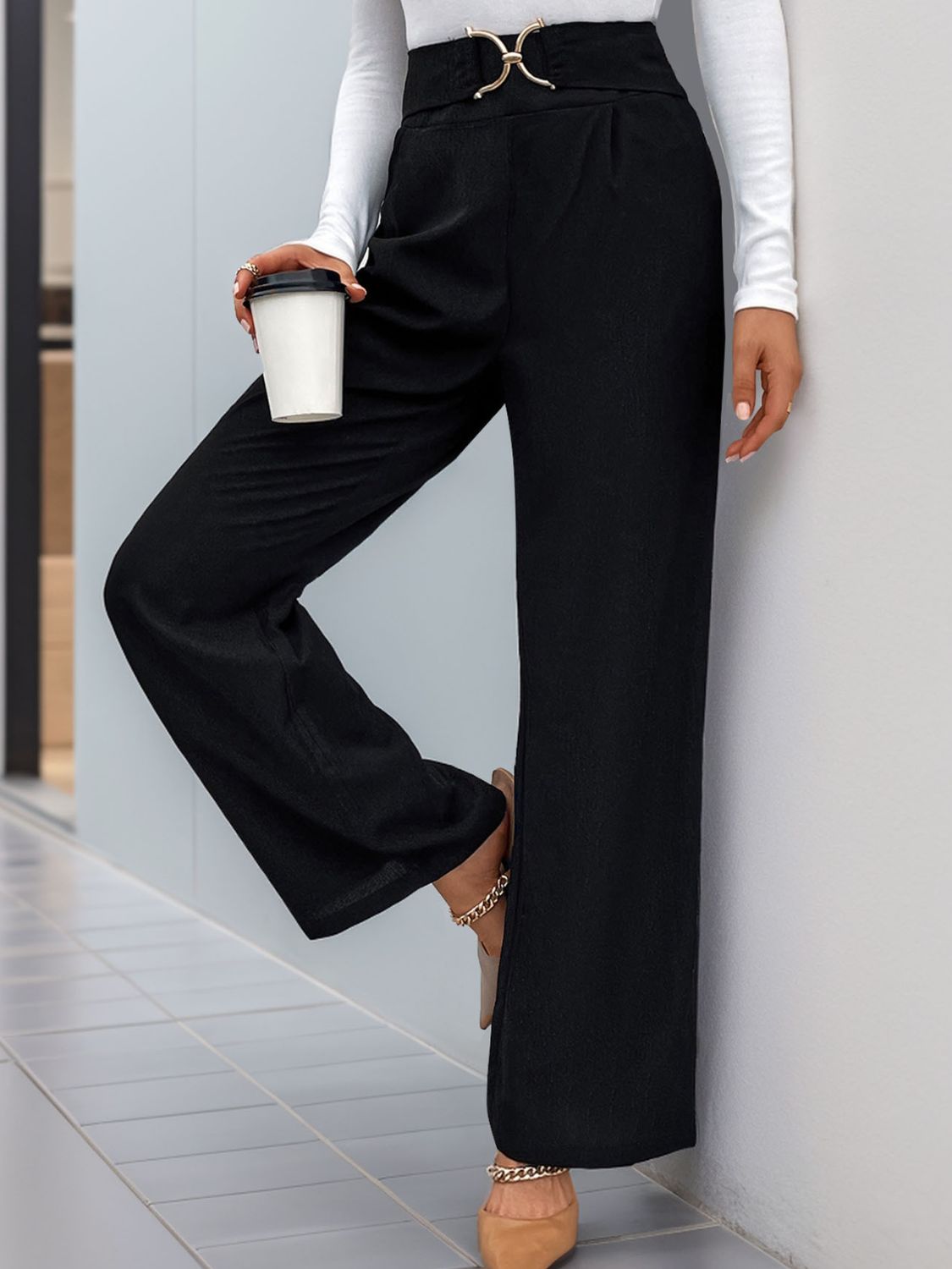 Black wide leg trousers with a gold buckle belt detail and a cinched waist.