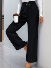 Black wide leg trousers with a gold buckle belt detail and a cinched waist.
