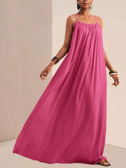 Fuchsia pink maxi swim dress with spaghetti straps and gathered bodice.