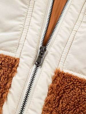 Cozy color block vest coat with beige quilted panels and brown sherpa accents, featuring a silver zipper.