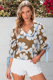 Floral print blouse in camel with Peter Pan collar and tie sleeves.