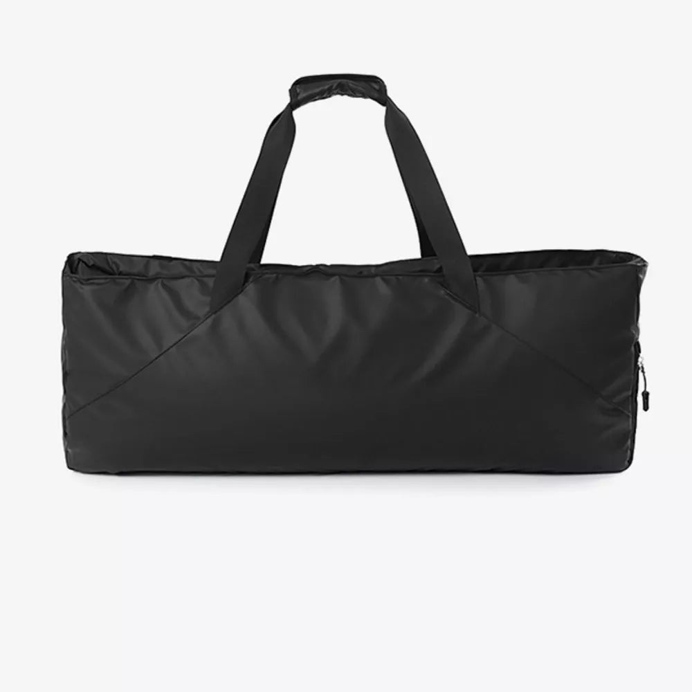 Black color block travel bag with dual handles and a zippered side pocket.
