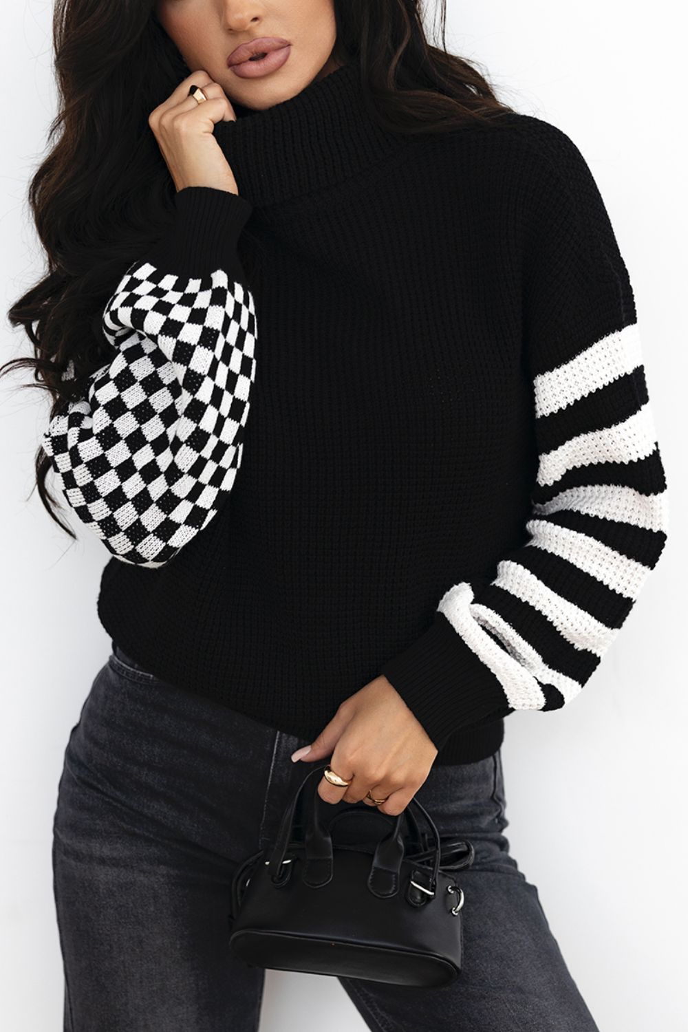 Black acrylic turtleneck sweater with checkerboard and stripe sleeves