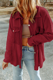 Chic red button-up coat with textured fabric and chest pockets.