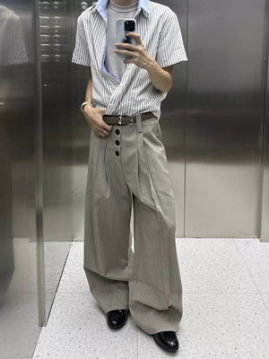 High-waisted wide-leg khaki pants with vertical pinstripes and a button fly.