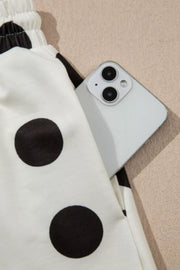 Polka dot lounge set with elastic waist and side pocket holding a phone.