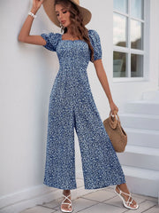 Royal Blue floral smocked bodice jumpsuit with puff sleeves and wide legs.