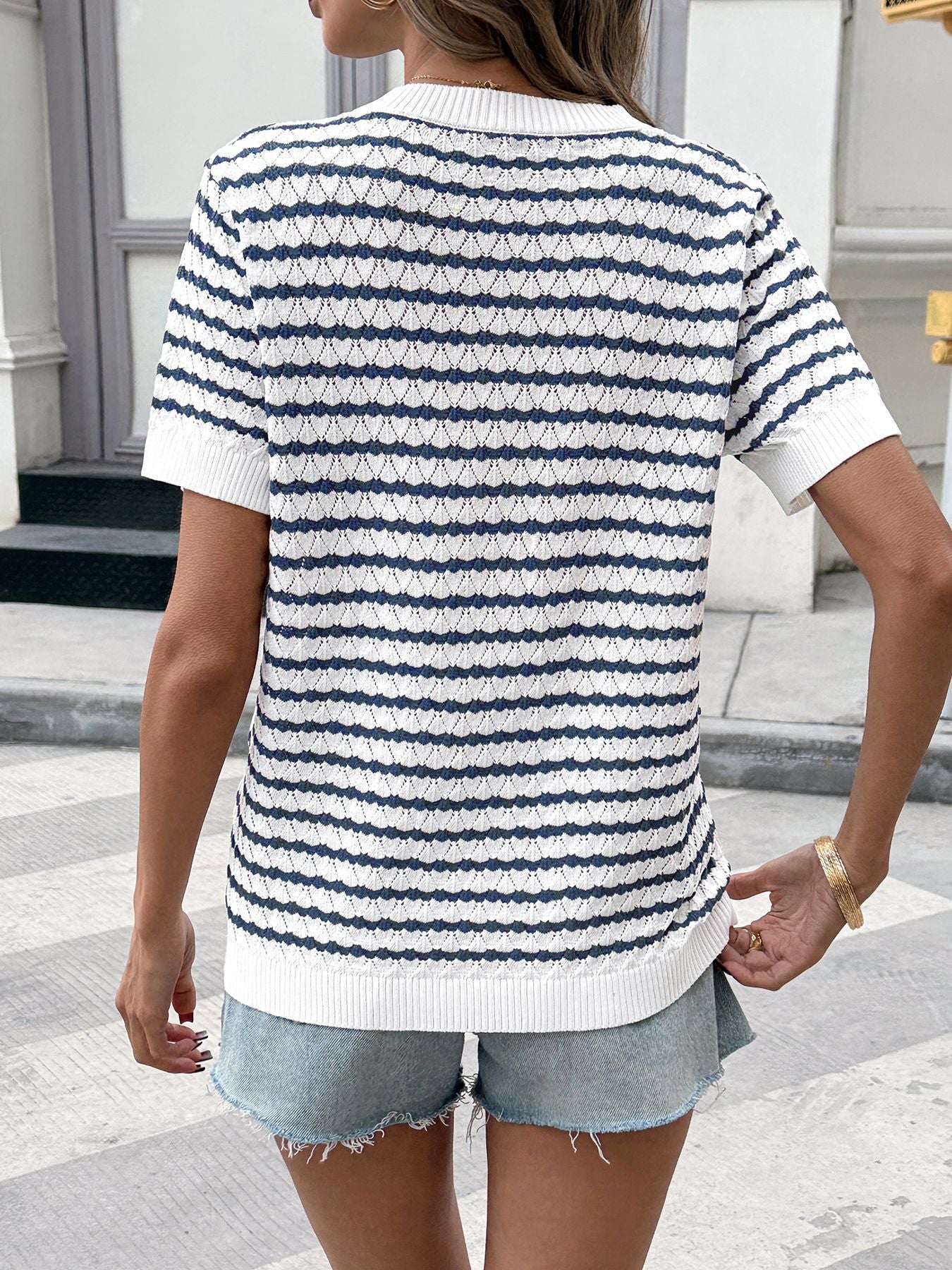 Chic striped knit top with button placket and short sleeves.