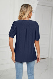 Dark navy perforated puff sleeve blouse with keyhole detail and subtle pleating.