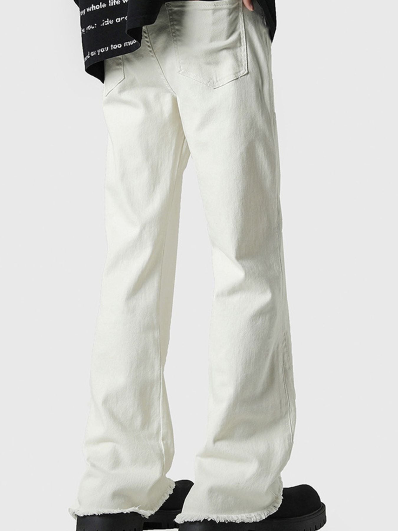 Men's white 100% cotton flare jeans with raw hem detail.