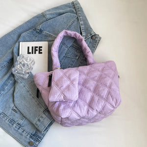 Quilted lilac shopper tote bag with top handles and a front pouch.